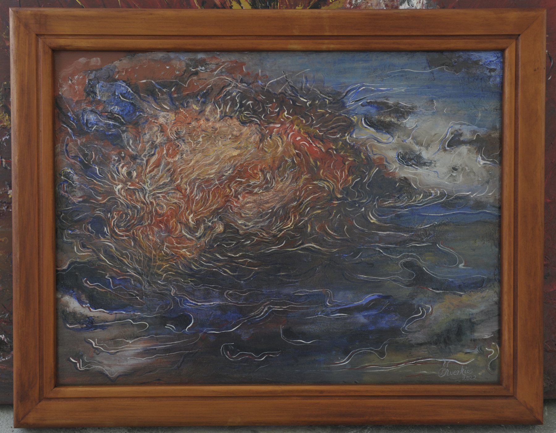 Landscape-format abstract painting with a central mass of fine wavy orange, red and white lines against dark blue and grey fields, in a wooden frame