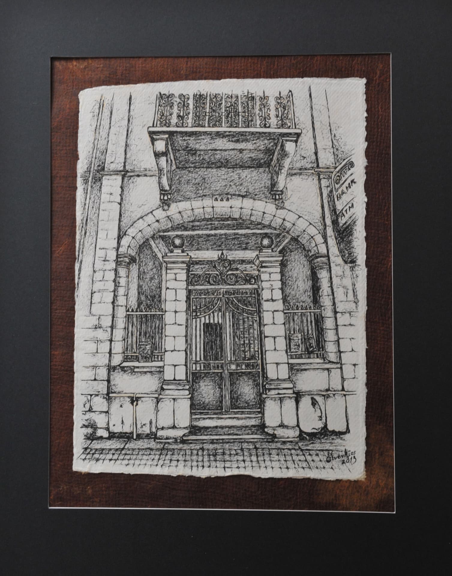 Ink drawing of an arched entryway with metal gates, flanking columns and an overhead balcony with iron railings, on paper mounted on a reddish-brown mat