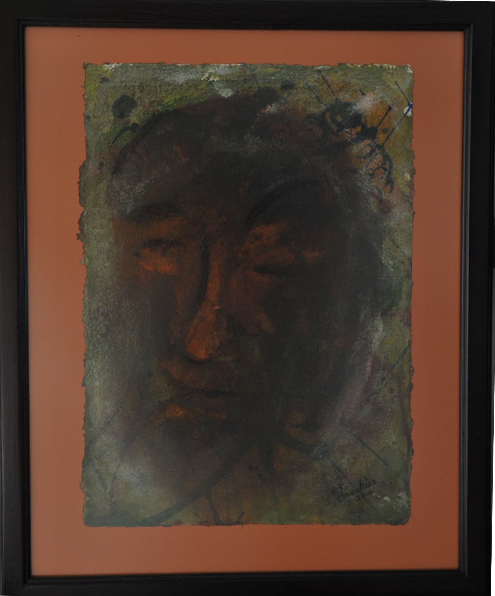 Frontal face with lowered eyes in dark brown, rust and muted olive wash over rubbed pigment, on deckle-edged paper mounted on a terracotta mat