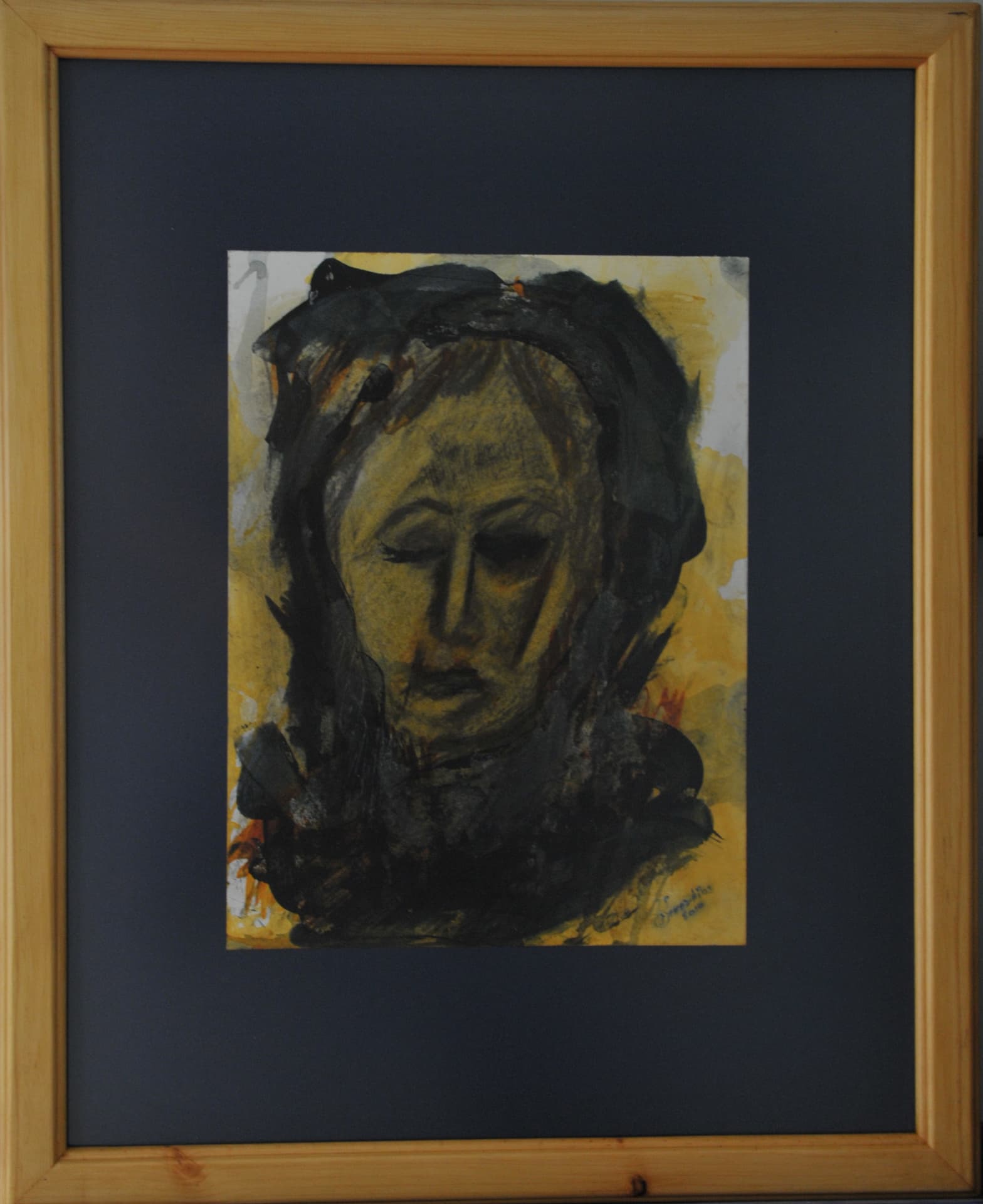 Head with closed eyes amid heavy black and yellow washes, on paper mounted on a dark navy mat in a light wood frame