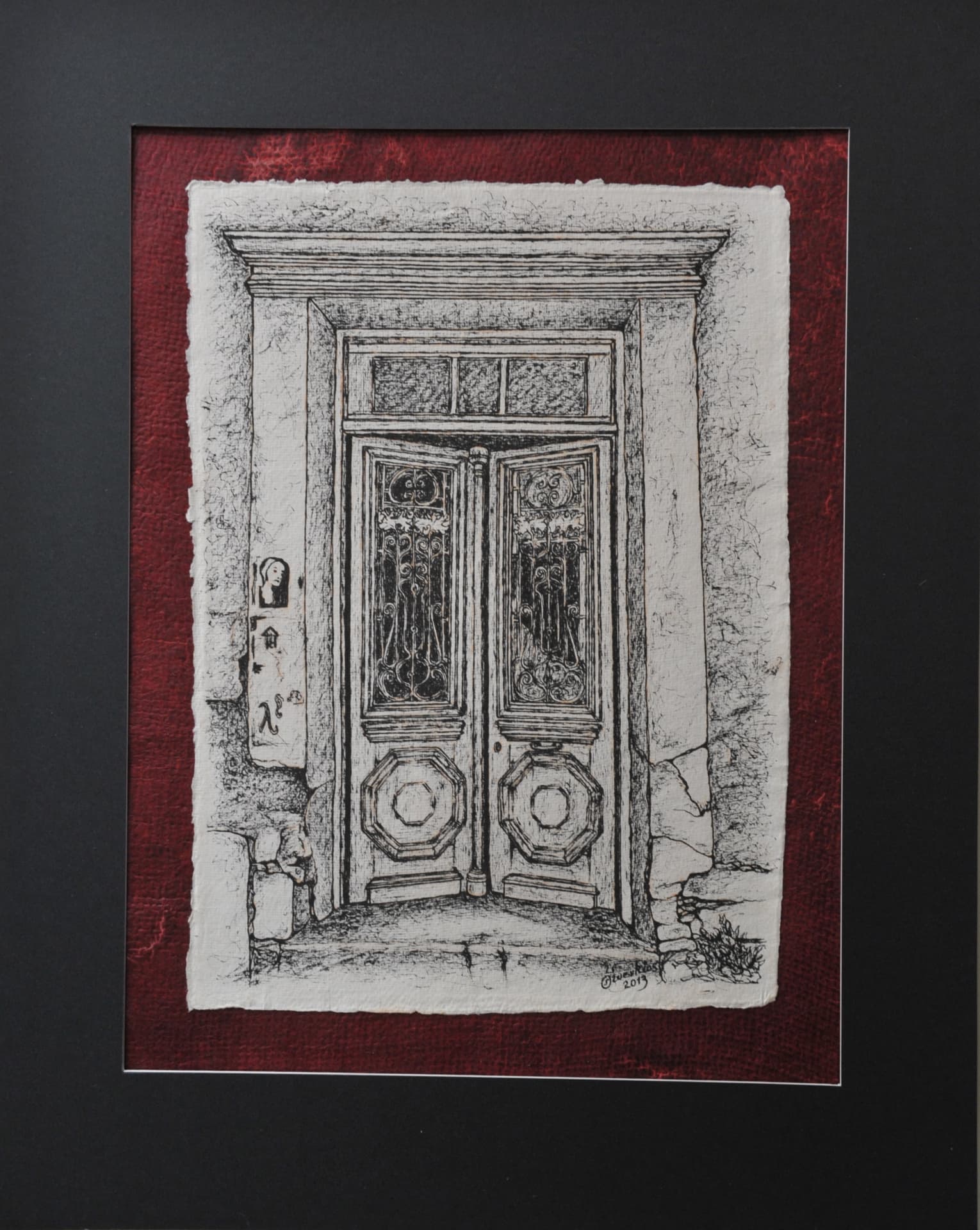 Ink drawing of a stone doorway with double doors behind a decorative iron grille, on paper mounted on a deep red mat