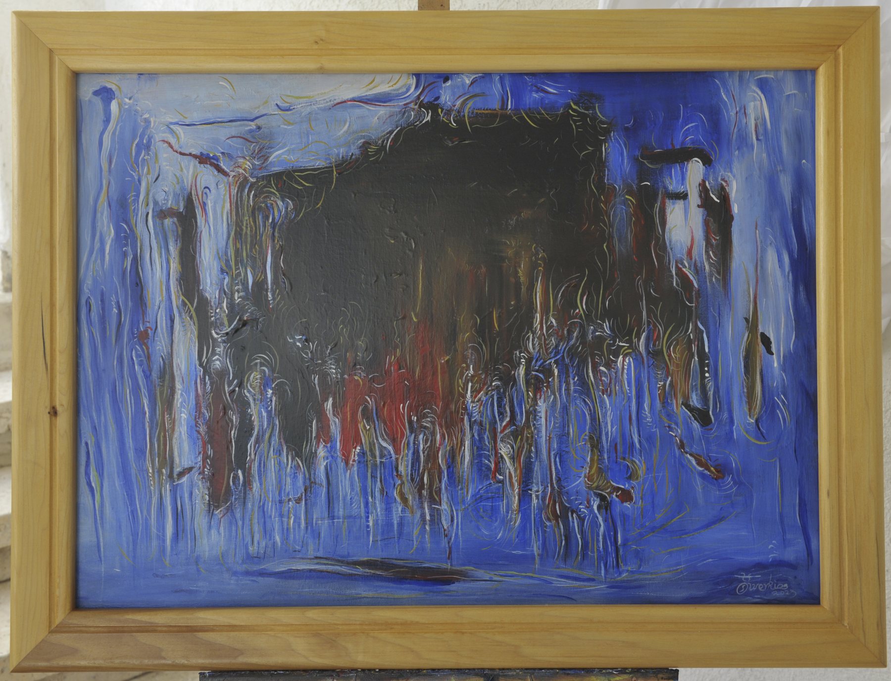Landscape-format abstract painting with a central dark mass and descending drip-like strokes in red against vertical blue and white marks, in a wooden frame