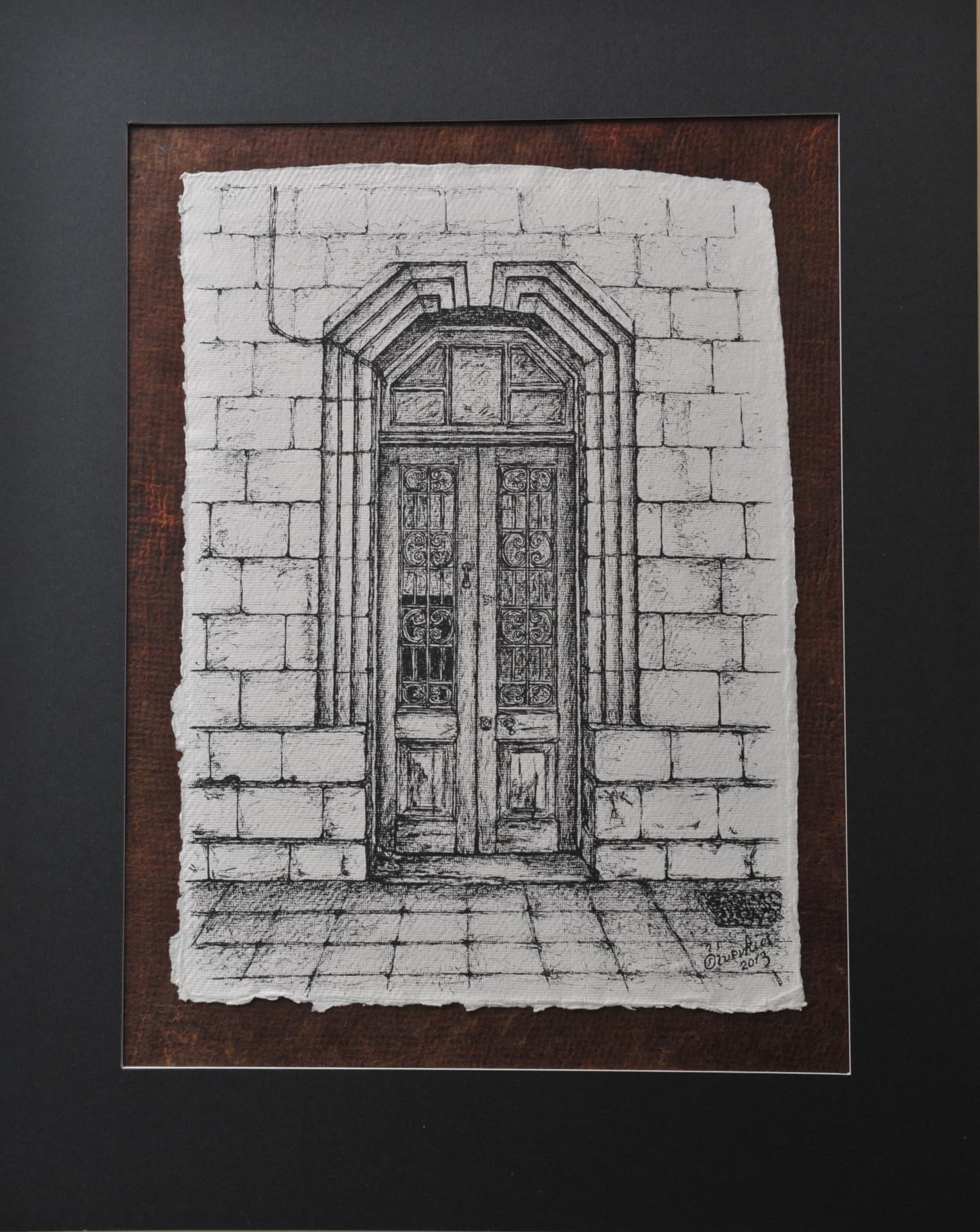 Ink drawing of a stone-framed double door with ornate glass and ironwork set into a masonry wall above a tiled pavement, on paper mounted on a reddish-brown mat