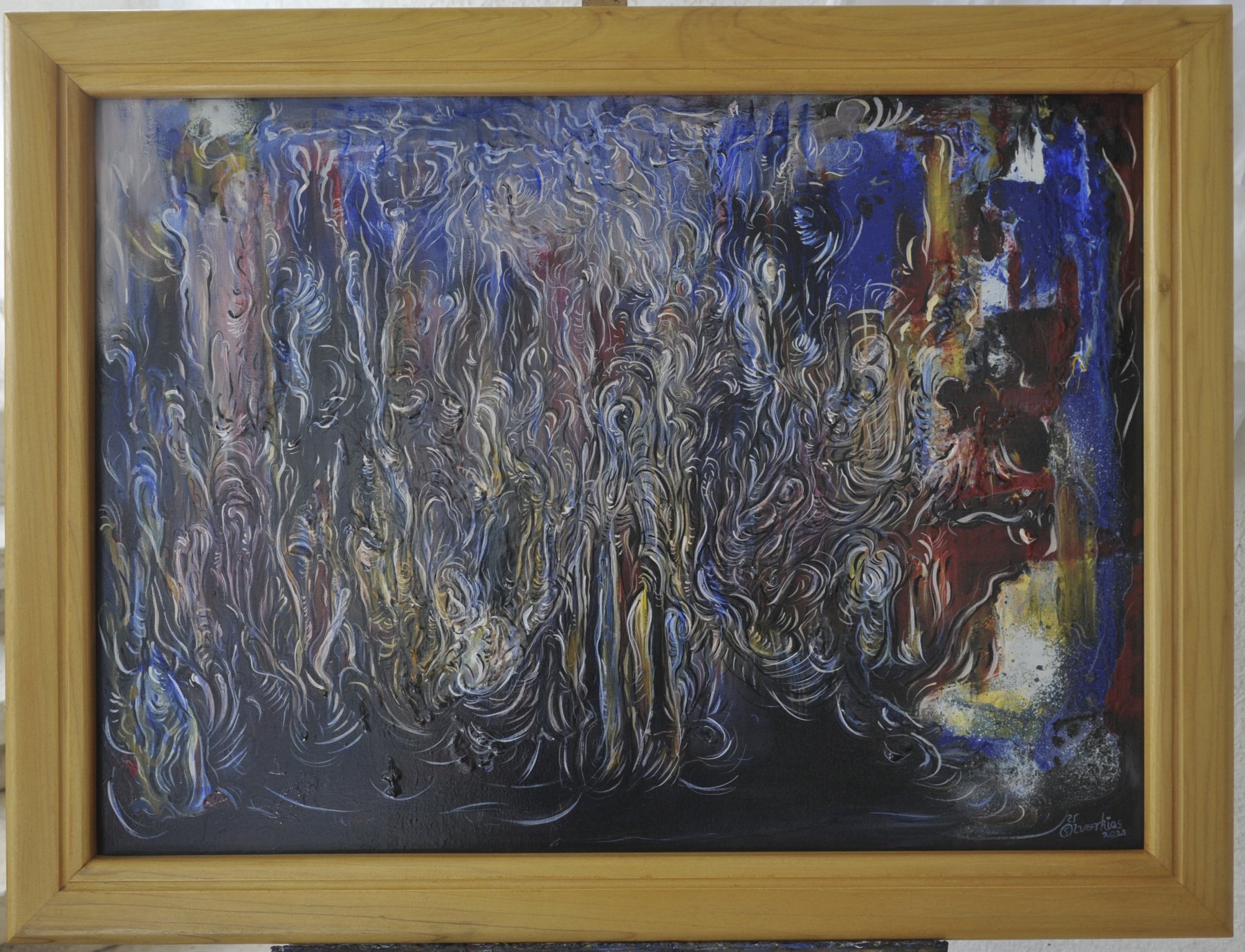 Landscape-format abstract painting with dense swirling fibrous lines and textured patches in black, blue and white, in a wooden frame