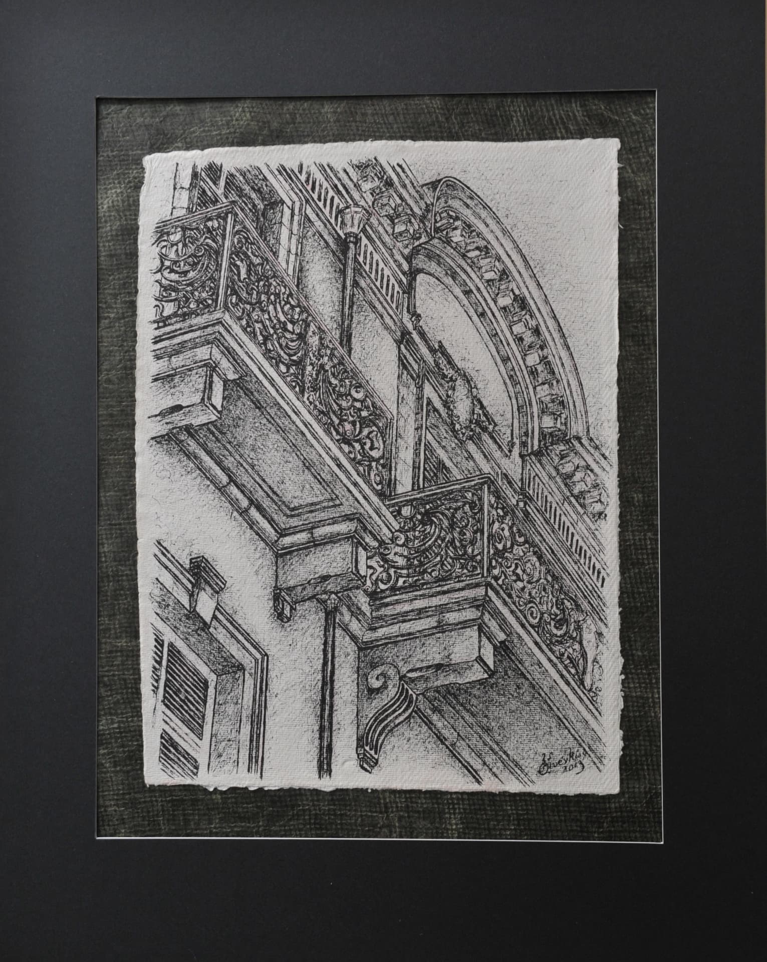 Ink drawing looking upward at ornate balconies and the arched pediment of a building facade, on paper mounted on a dark grey mat