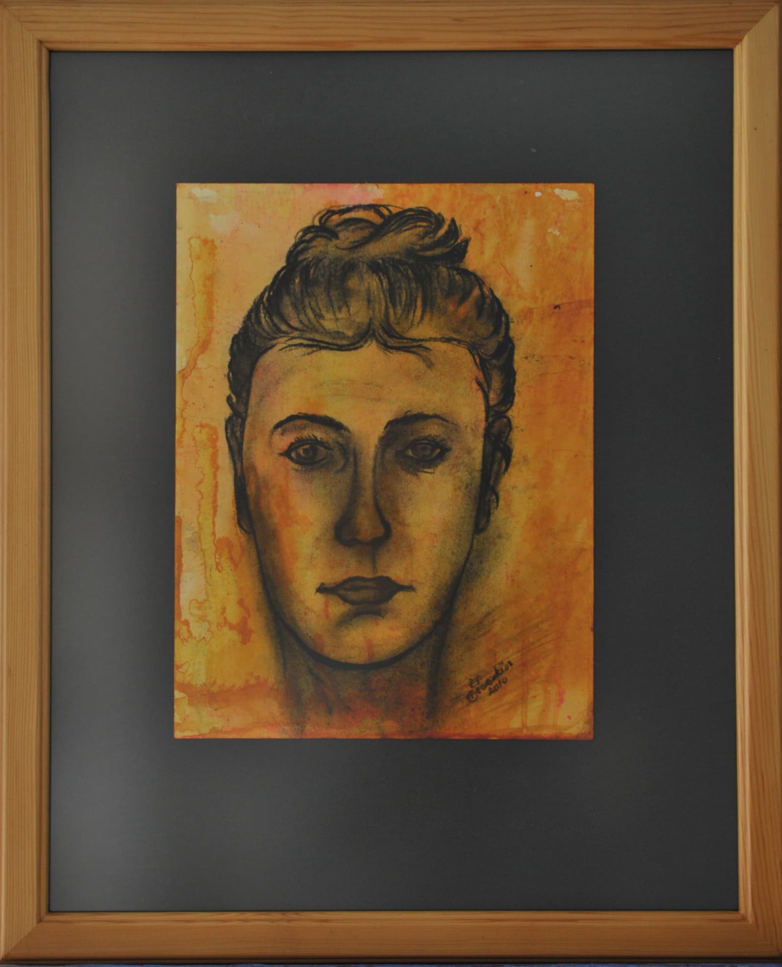Portrait of a face with hair gathered at the crown, in dark linework over a warm yellow and orange wash, on paper mounted on a grey mat in a light wood frame