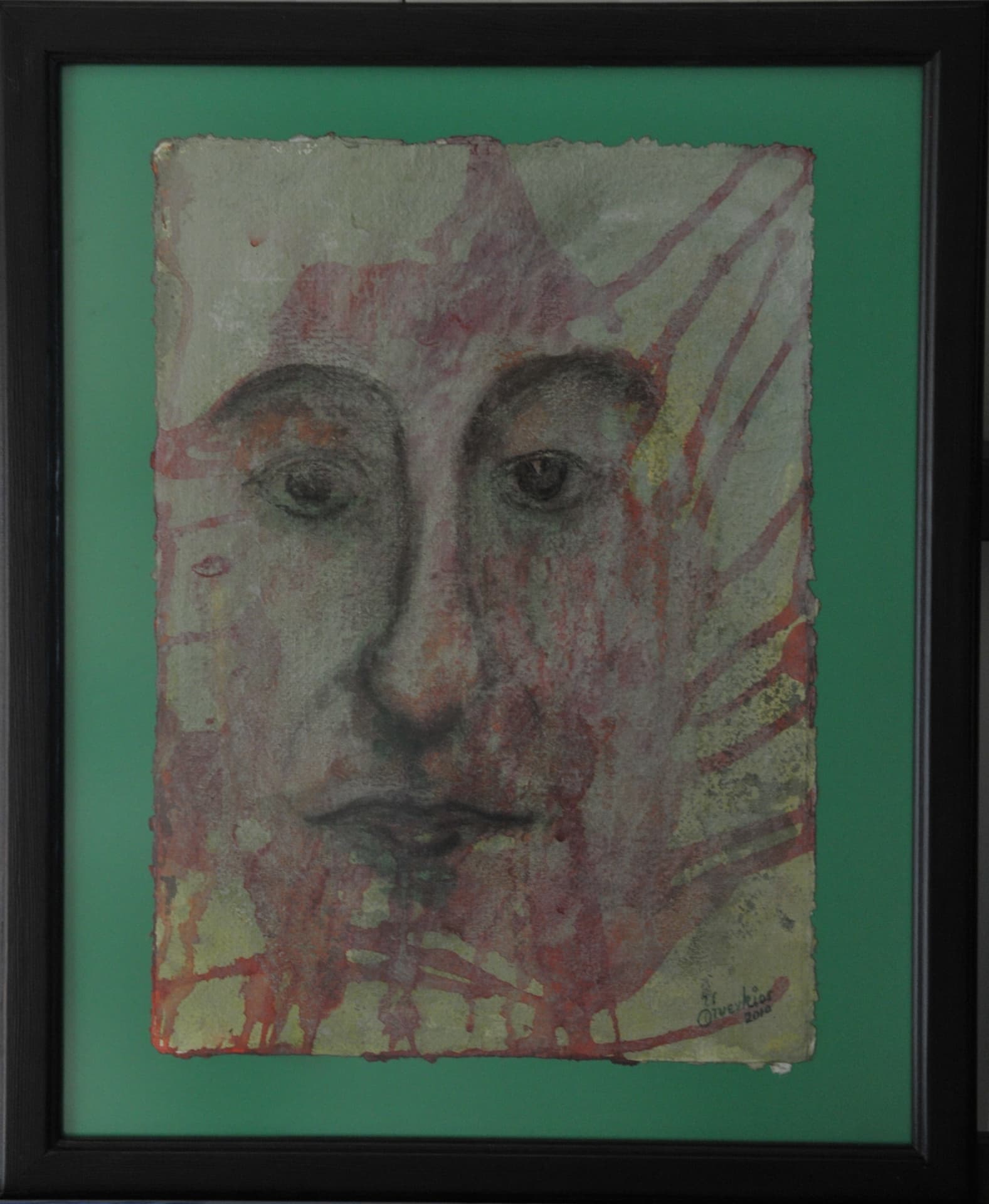 Face defined by fine dark lines beneath running washes and diagonal crimson streaks, on deckle-edged paper mounted on a green mat