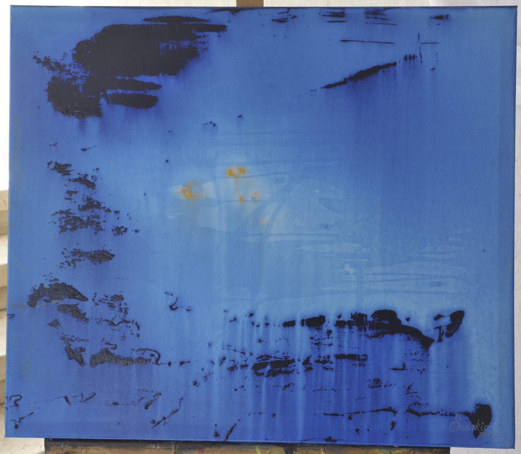 Nearly square abstract painting with thick dark patches, horizontal scrape marks and vertical drip lines over a blue field