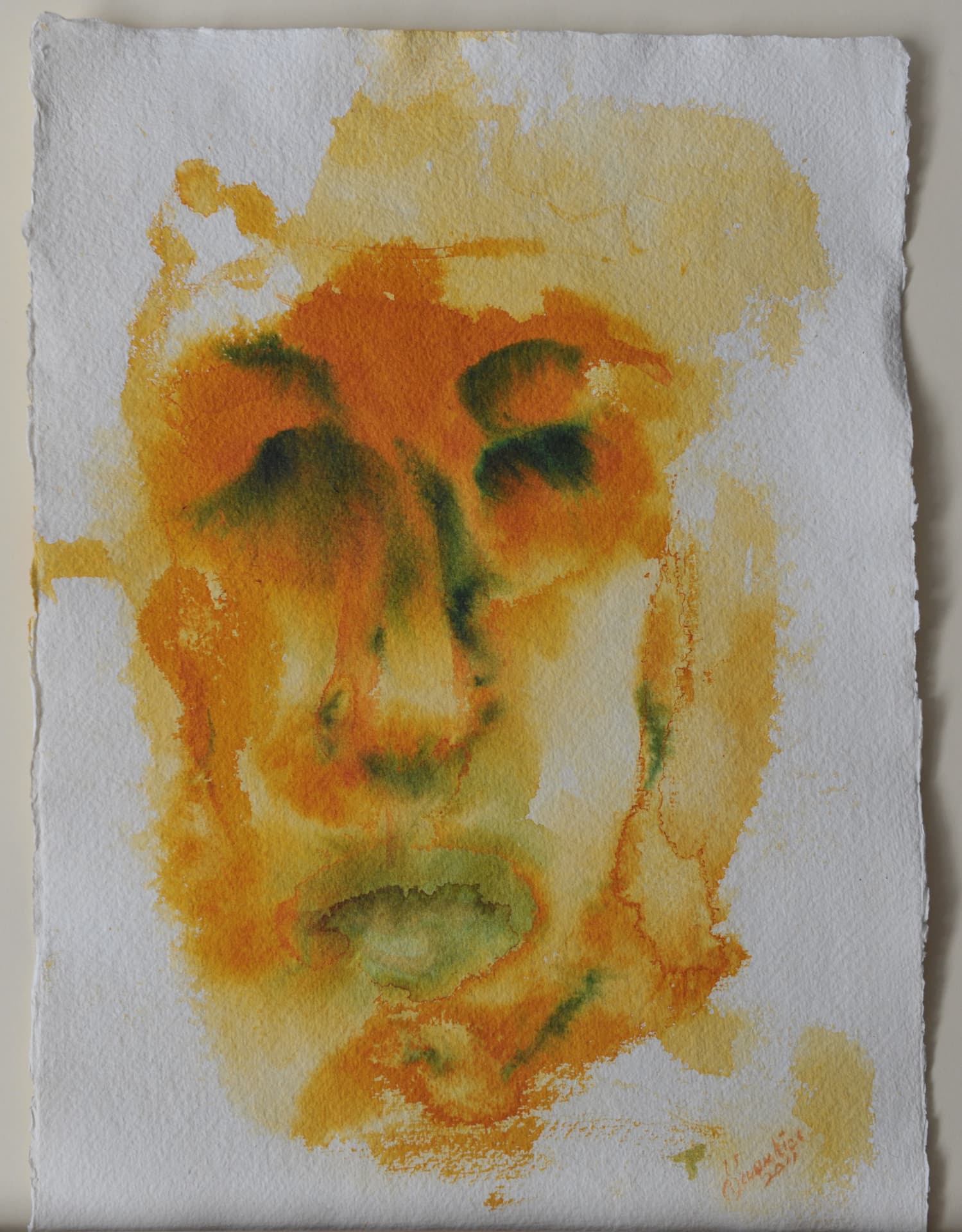 Face in orange and green watercolor washes on white deckle-edged paper
